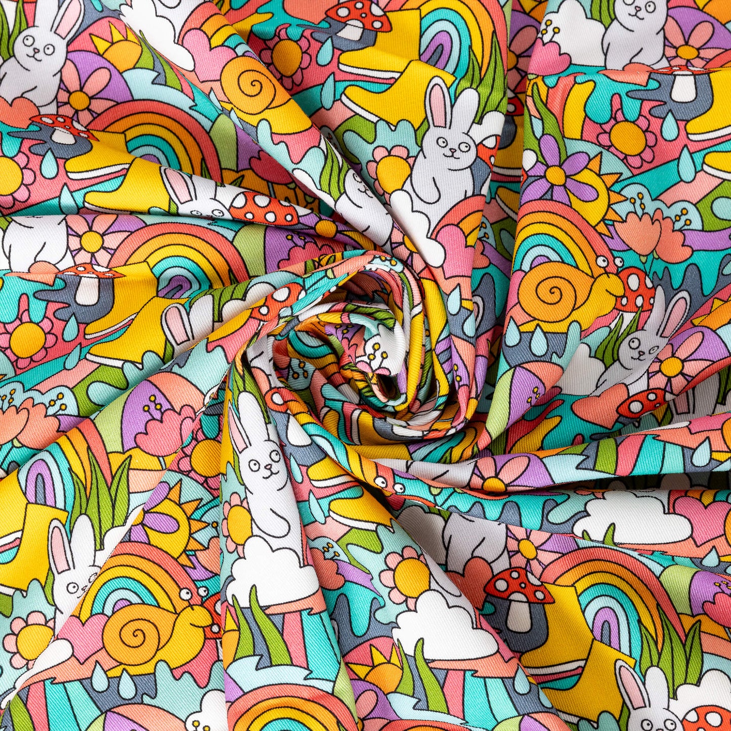 The Some Bunny Loves You Stretch Twill Fabric swirled and folded into the centre. The colourful stretch cotton fabric features smiling white bunnies, red toadstool mushrooms, umbrellas, rainbows, sunshines, rainclouds, raindrops, snails, hearts, grass and flowers.
