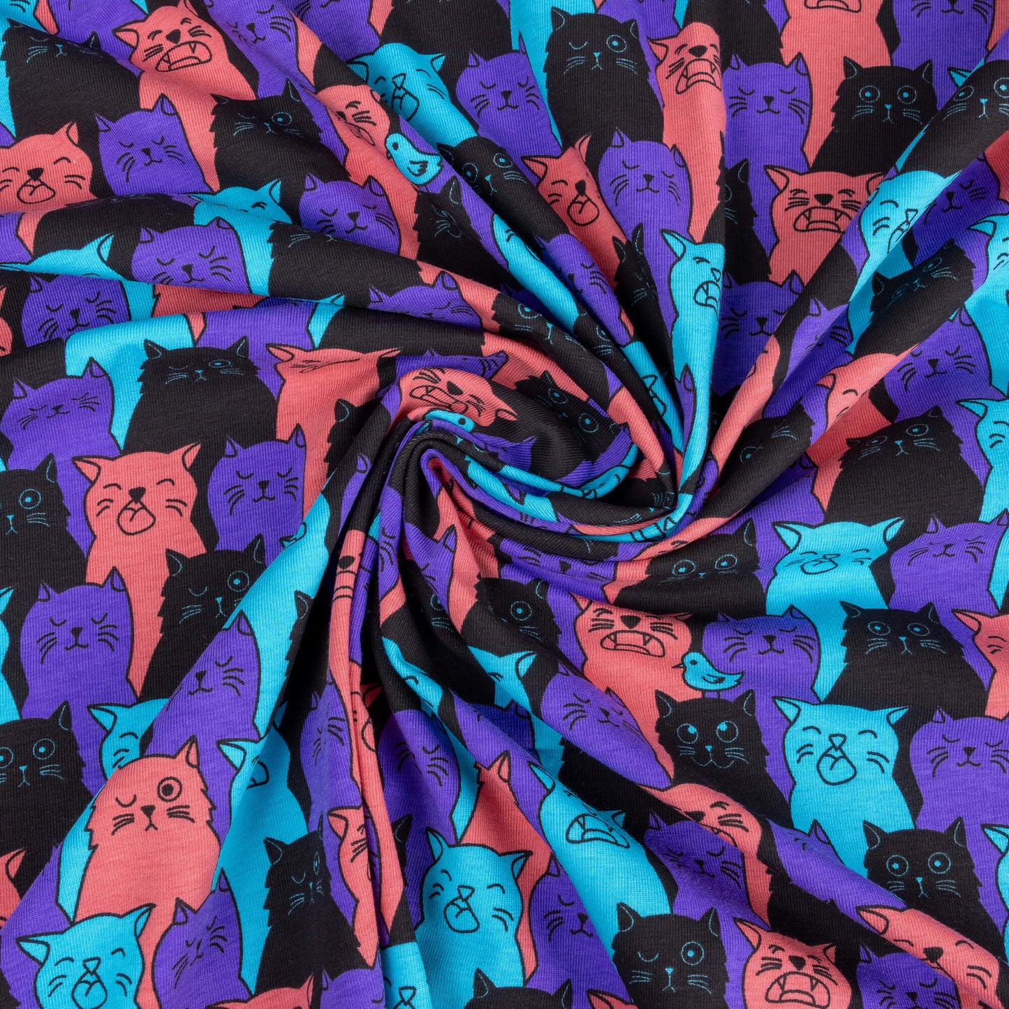 A swirly stretch jersey fabric featuring cats that look like they are winking, singing or have their eyes shut, their is a bird one one of their heads. They are purple, black, pink and bright blue.