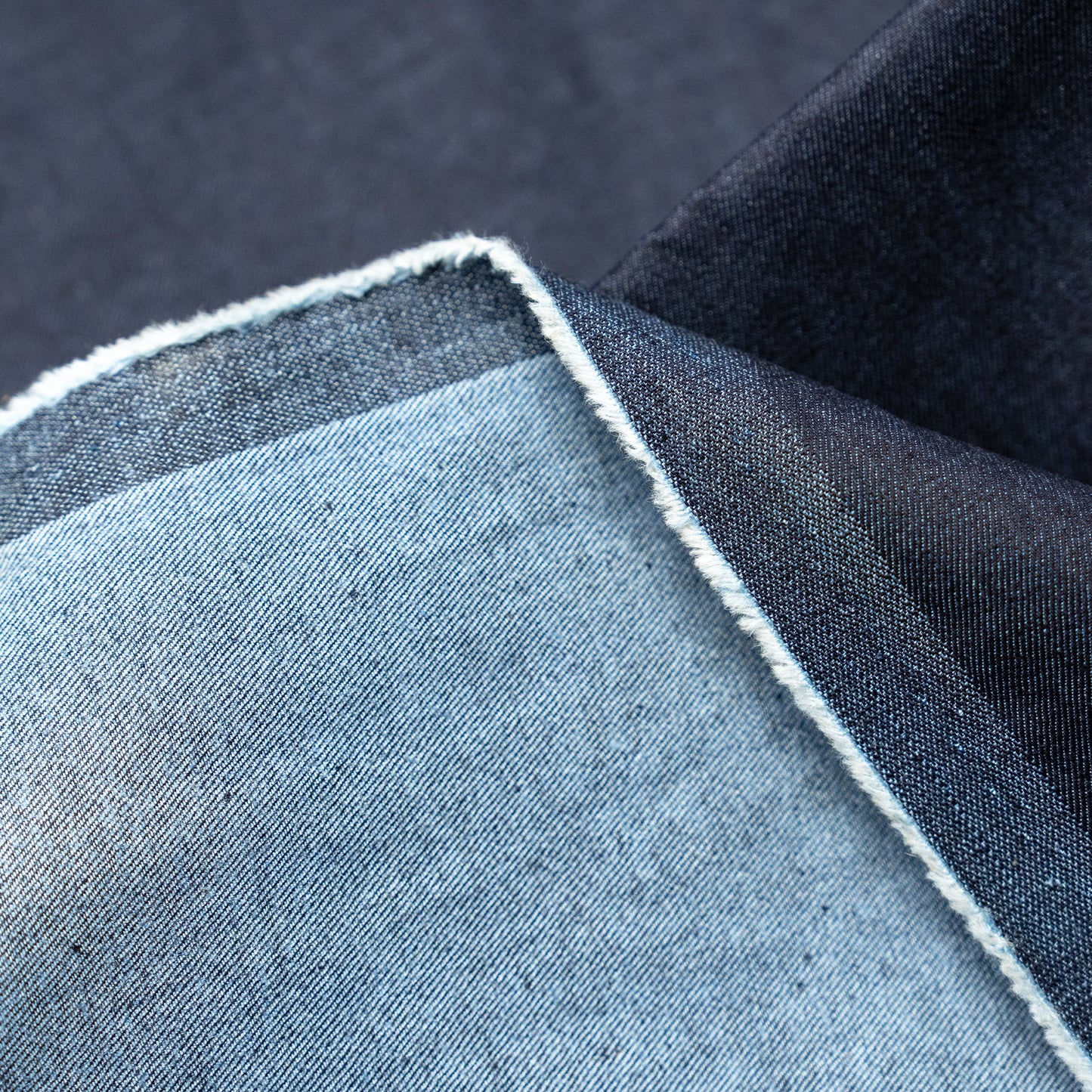 Indigo denim fabric with visible selvedge edge, showing dark blue front and pale reverse—great for Run & Fly-style creations.
