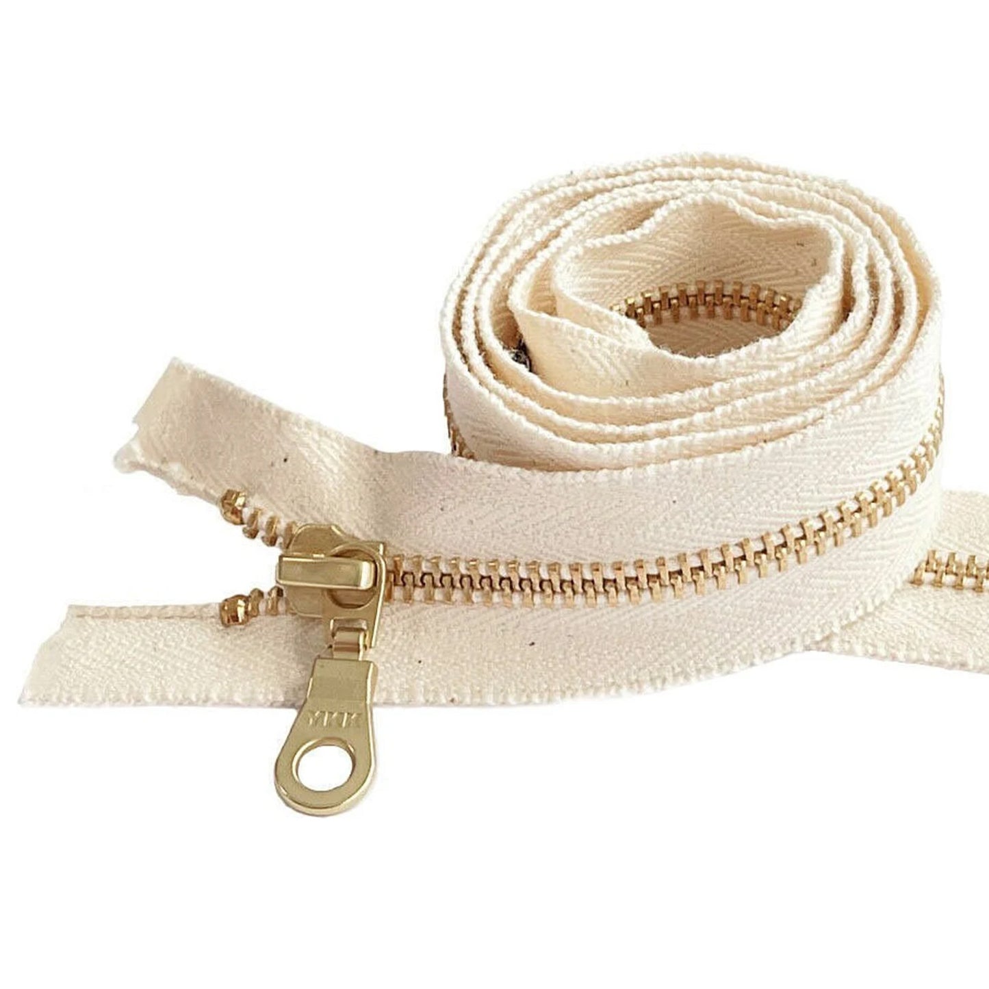 A close up of a twisted zip with YKK printed on the zipper