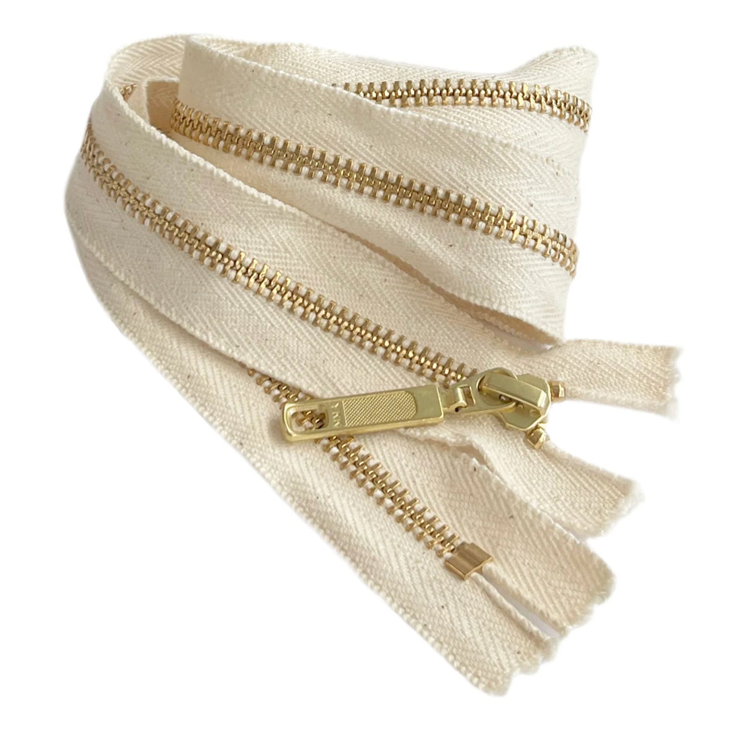 A close up of a twisted zip with YKK printed on the zipper