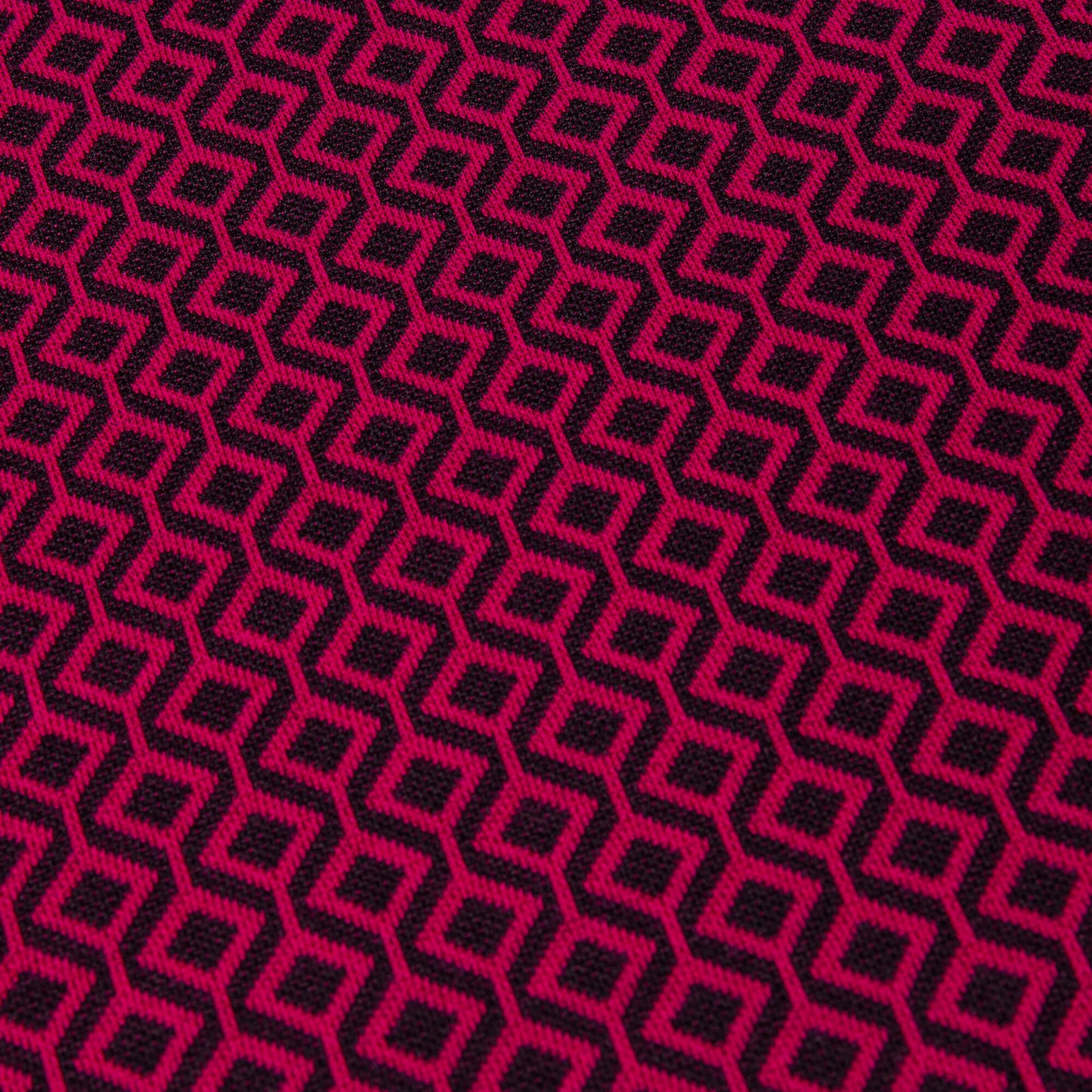 A close up of black and burgundy jacquard print on a lovely stretch jersey fabric, the fabric takes up the whole image.