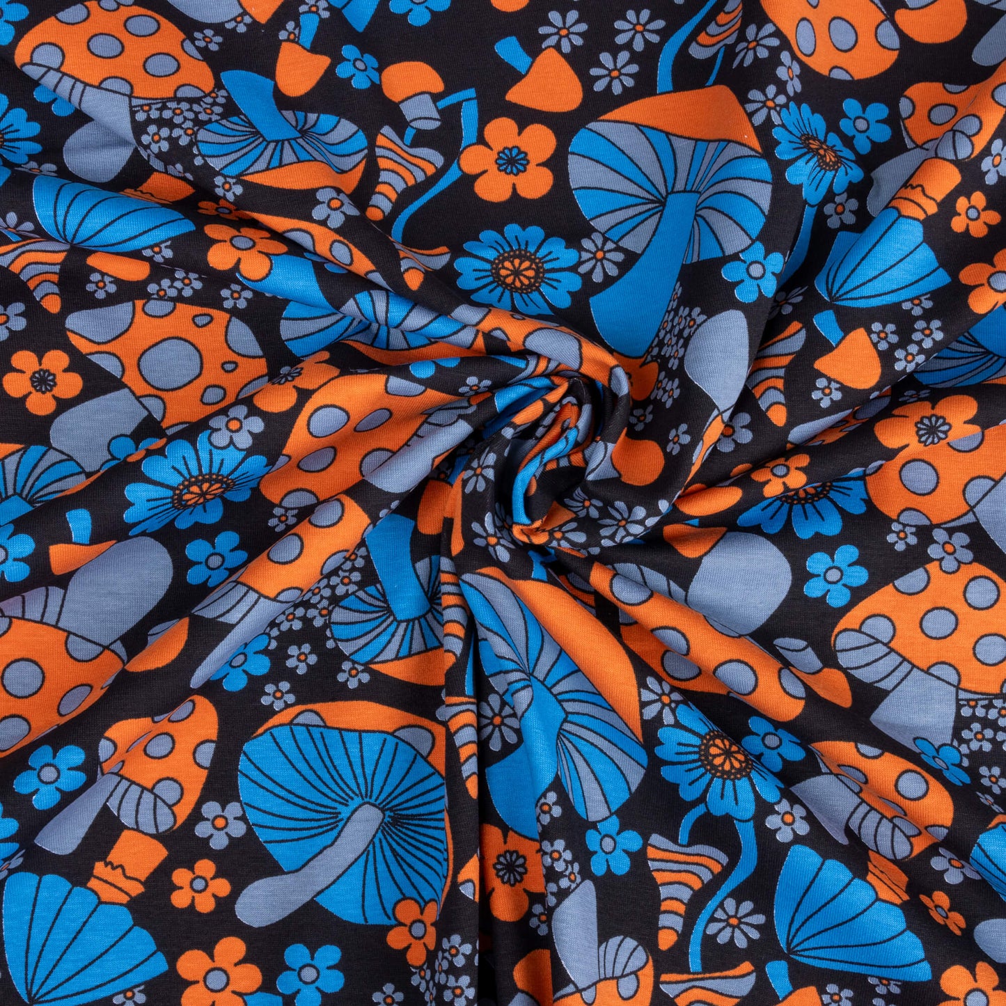A swirl of the magic mushroom fabric with blue, and orange mushrooms and flowers in a trippy 70's style on a black background
