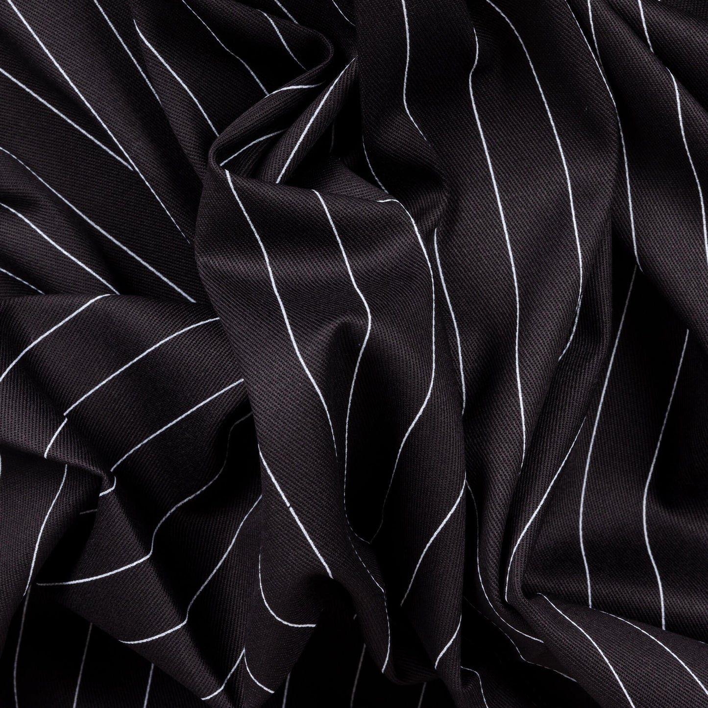 a messy black and white pinstripe fabric all twisted up to show its versatility