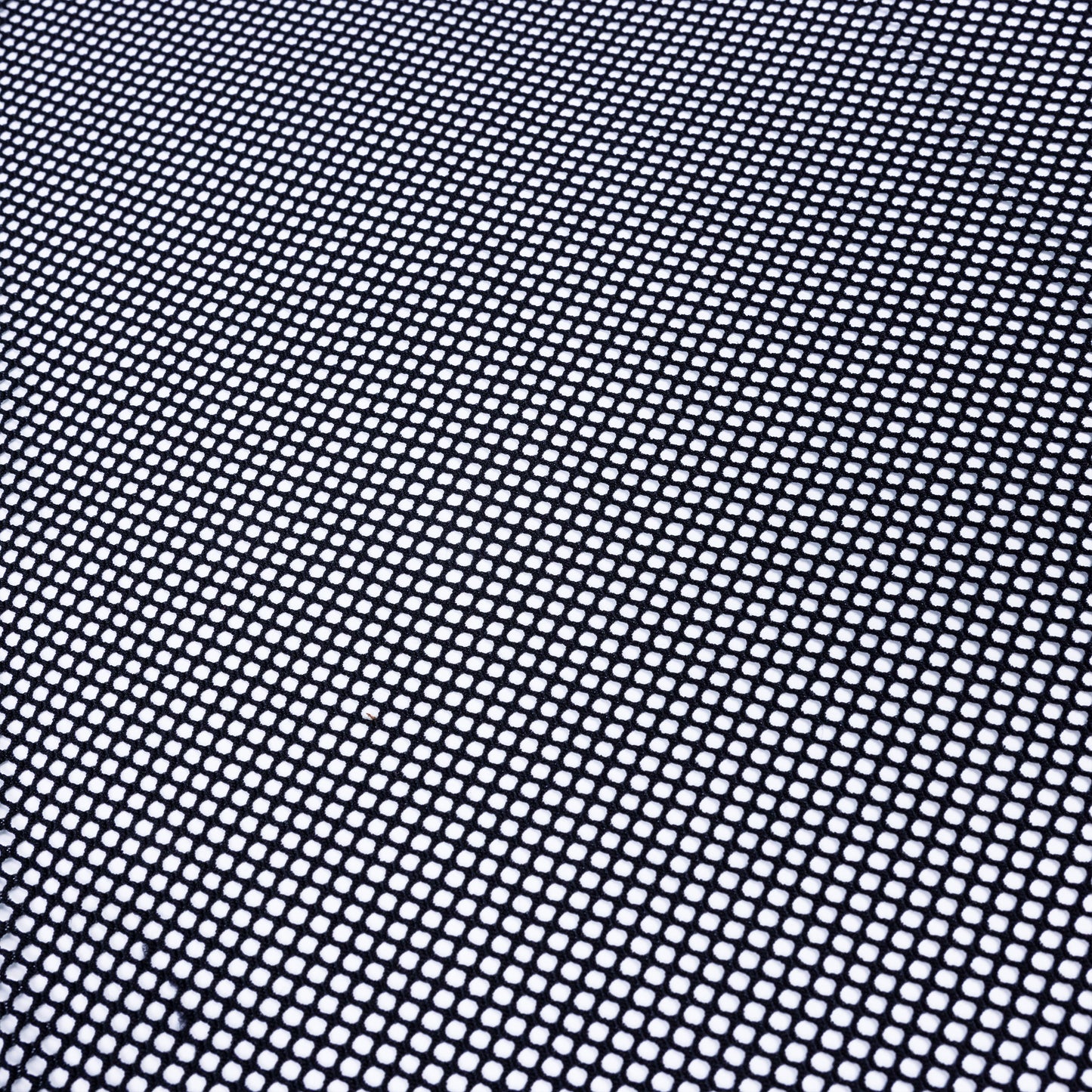 black fishnet power mesh fabric on top of a white background to show off its structure and lots of holes