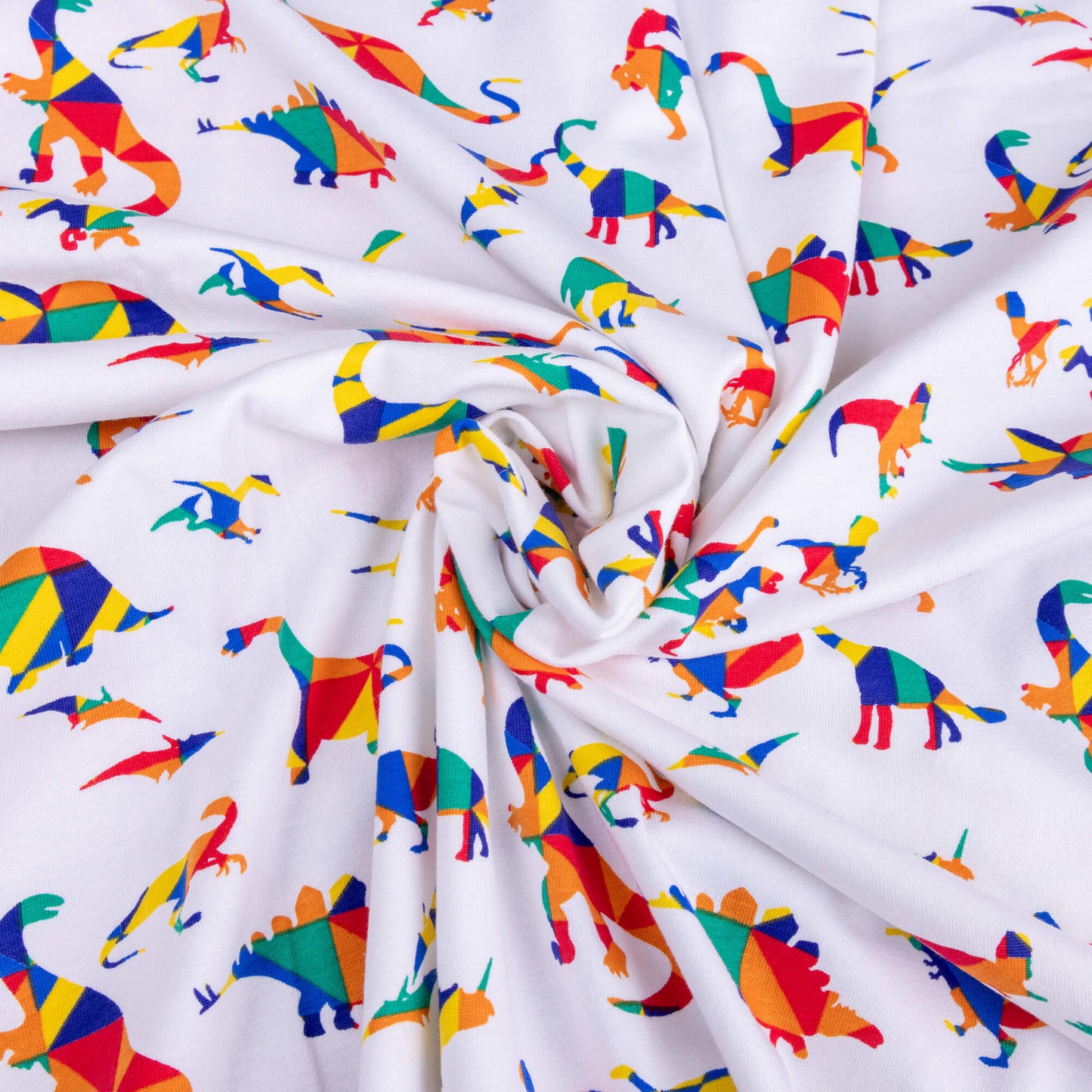 A swirl of the White Rainbow Dinosaur Stretch jersey fabric it has different dinosaurs on a white background the dinosaurs are in bold primary colours in a kaleidoscope style