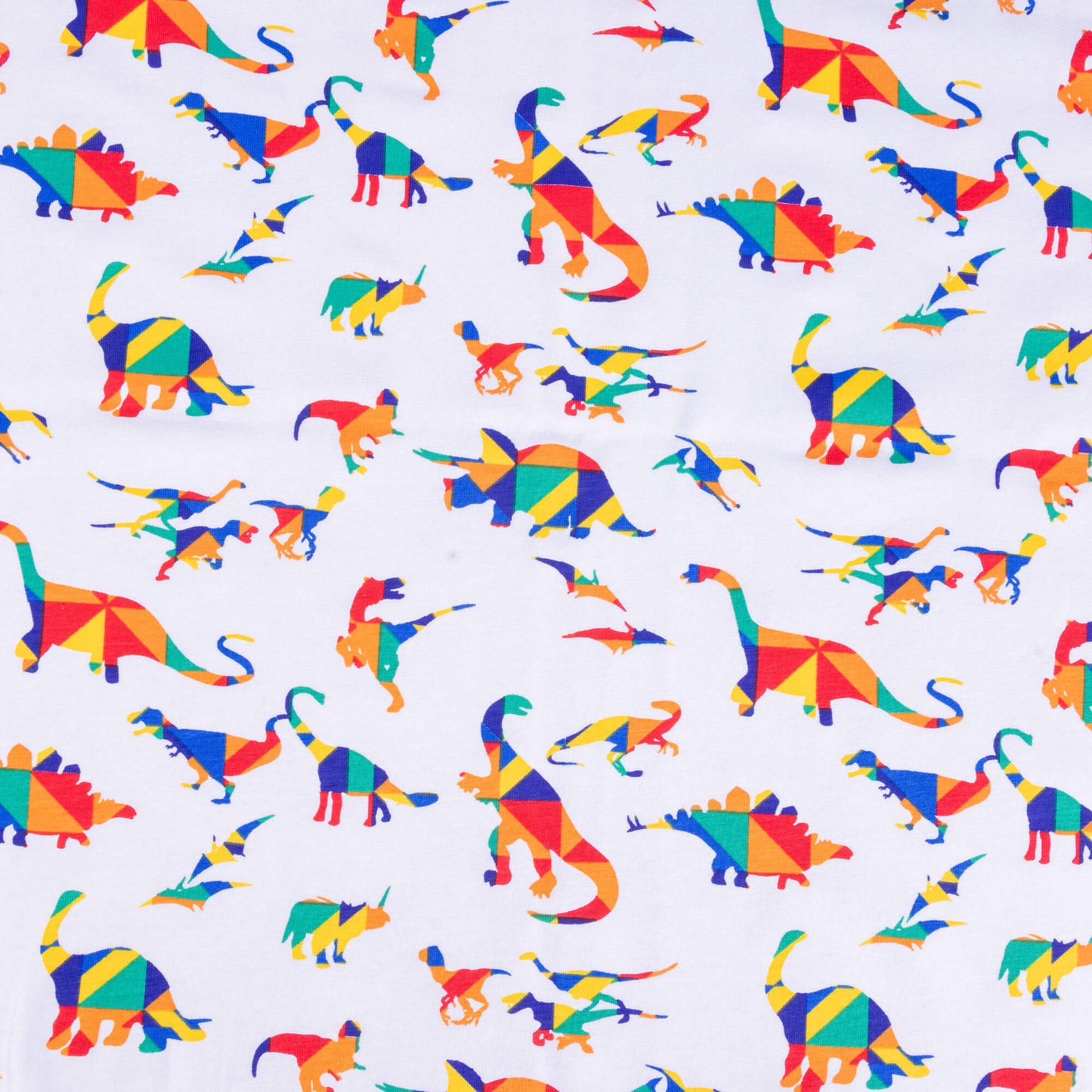 A wide look at the White Rainbow Dinosaur Stretch jersey fabric it has different dinosaurs on a white background the dinosaurs are in bold primary colours in a kaleidoscope style