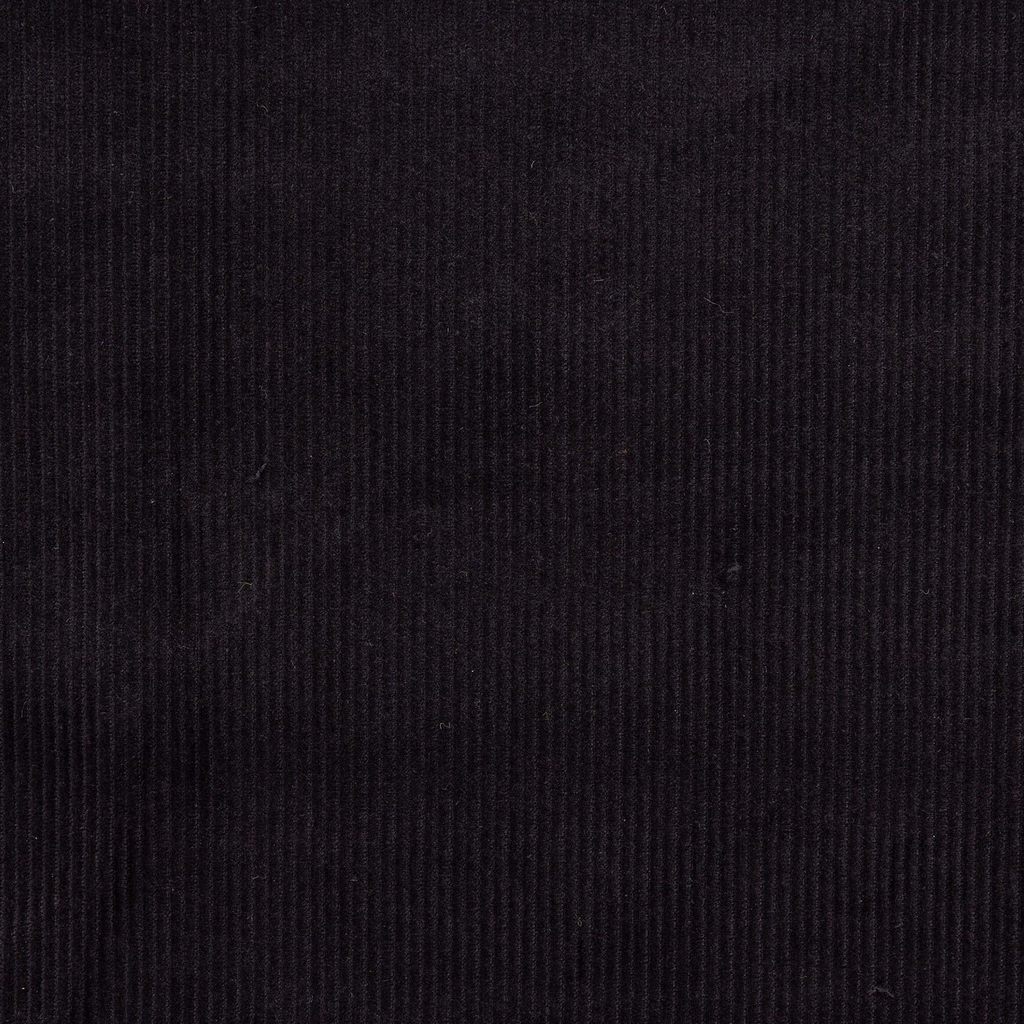 close up view of black corduroy fabric in neat rows for crafting, dressmaking and fabric projects