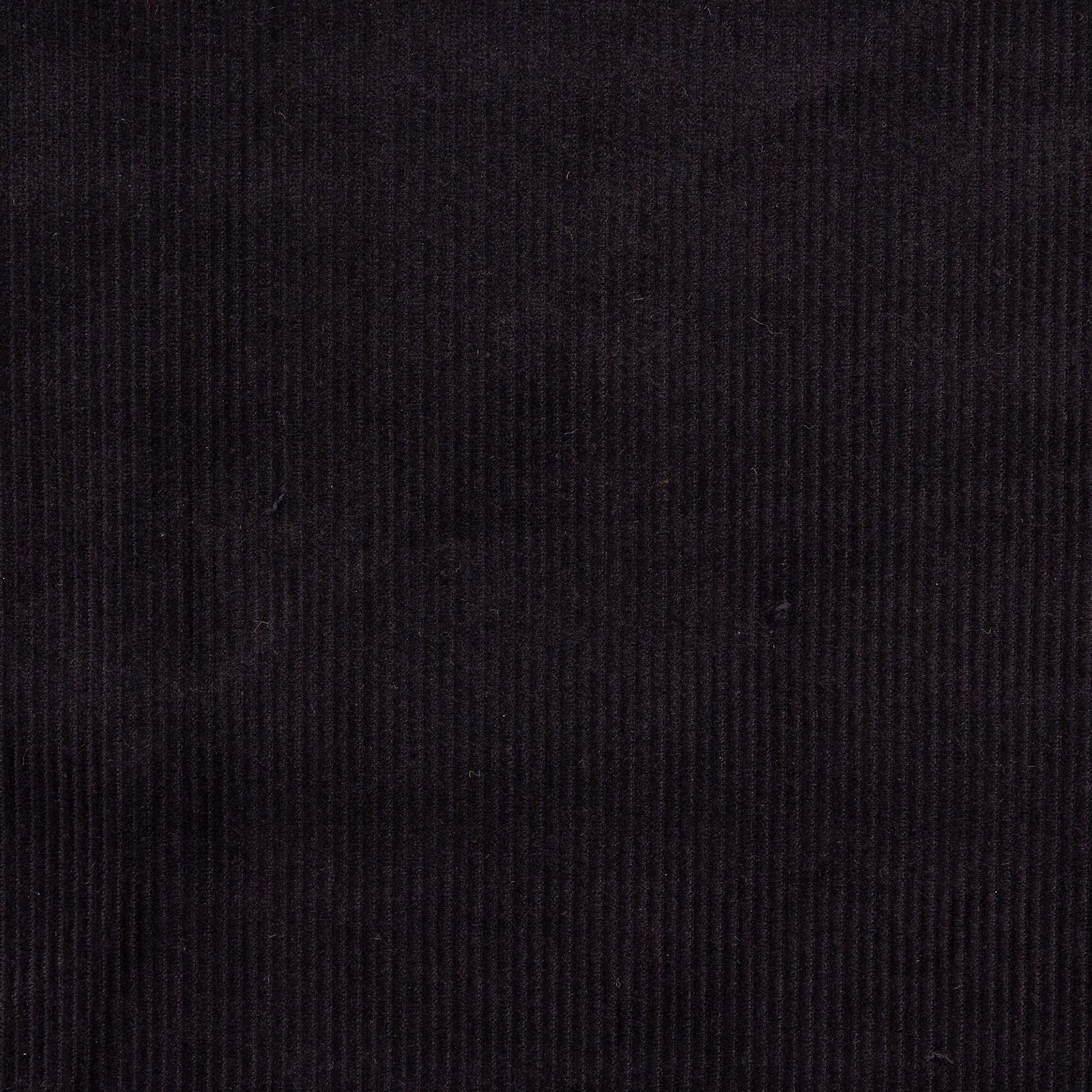 close up view of black corduroy fabric in neat rows for crafting, dressmaking and fabric projects