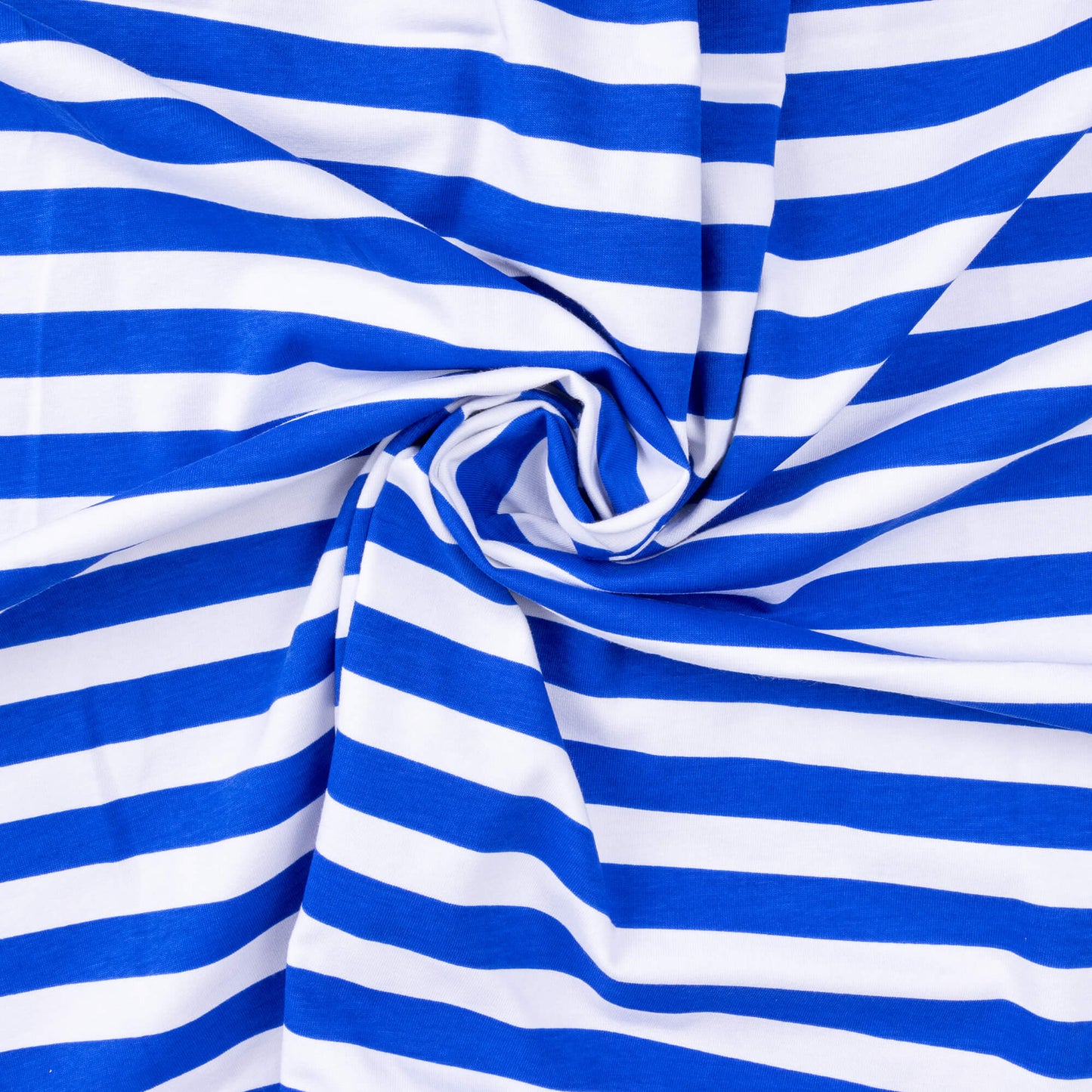 A swirled twist of bright blue and white striped t-shirt weight stretch fabric for craft projects and making clothing