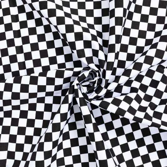 twisted up swirl of black and white checkerboard stretch twill fabric for dungarees and heavier duty crafting projects