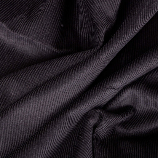 picture of black corduroy fabric, the cord fabric looks like it is in waves and is ready for craft projects 