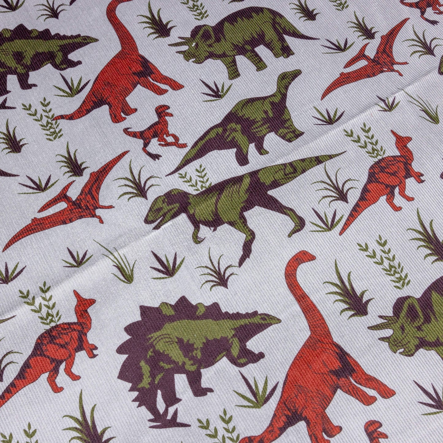 A portion grey dinosaur fabric in stretch corduroy by Run & Fly