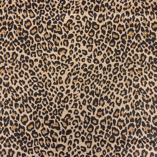 A close up of brown leopard print fabric with black, beige and a soft beige background the tones are warm 