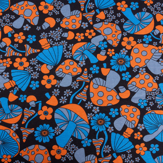A look at the magic mushroom fabric with blue, and orange mushrooms and flowers in a trippy 70's style on a black background