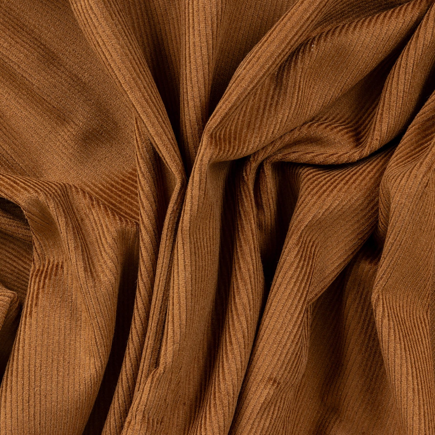 A crumpled up portion of the tobacco coloured 11 wale 100% cotton corduroy fabric