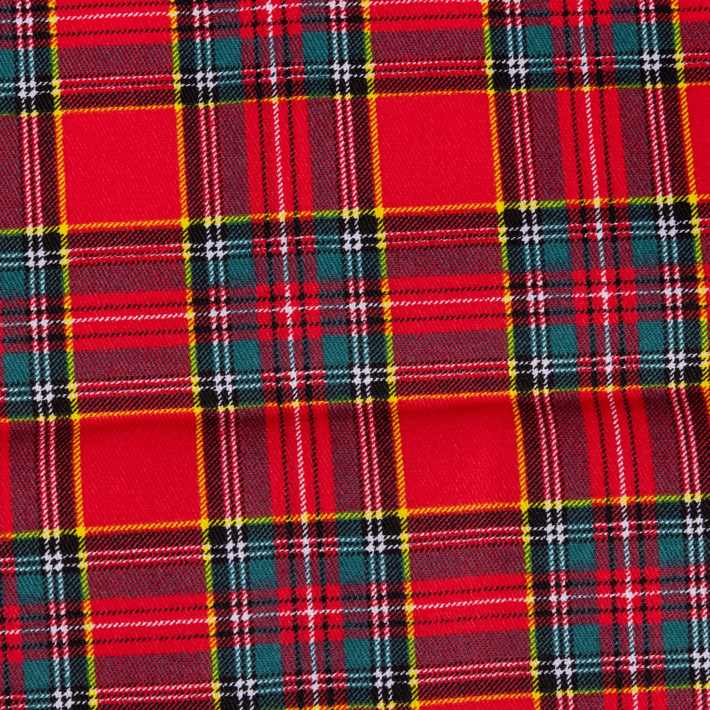 A close up of Red tartan fabric  showing yellow, white, green and navy against a red background