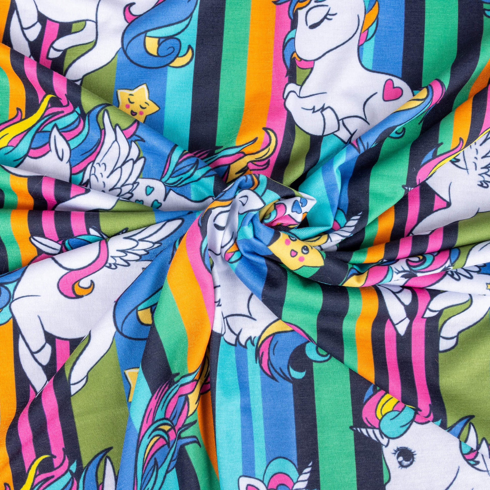 A swirl of Jersey fabric featuring unicorns and flying unicorns with pink, blue and yellow flowing hair against a background of pink, blue, yellow, green and black stripes. There are also cute smiley stars 